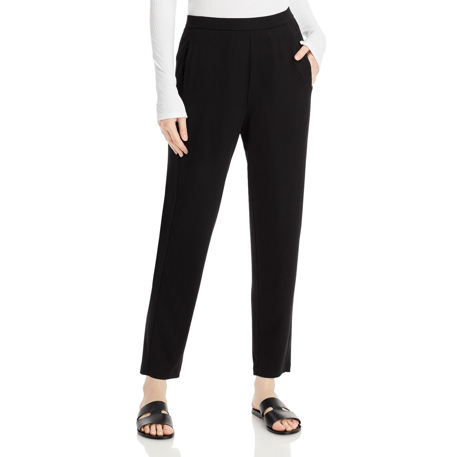 Black pants worn by a person on a white background