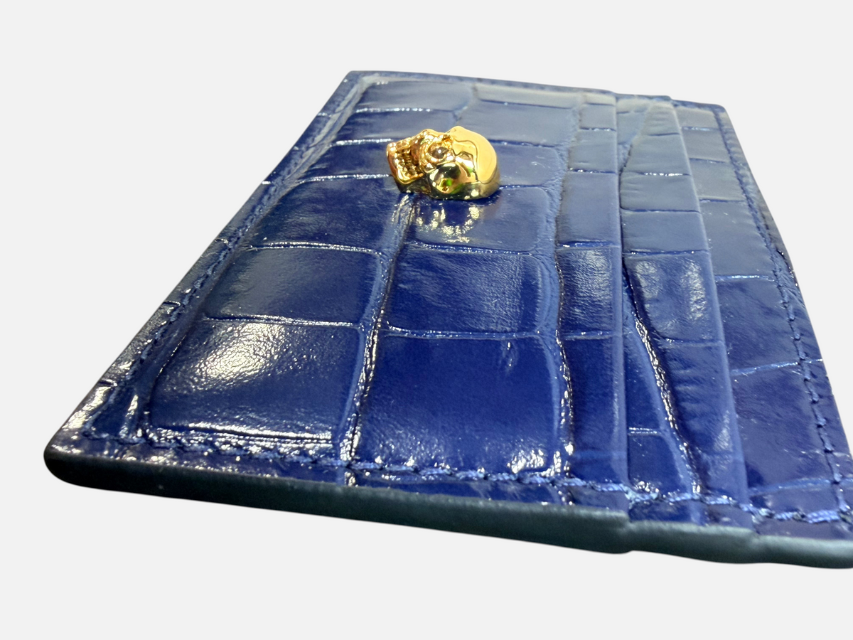 CURATED by Kira navy crocodile embossed patent leather card holder featuring a signature gold skull emblem.