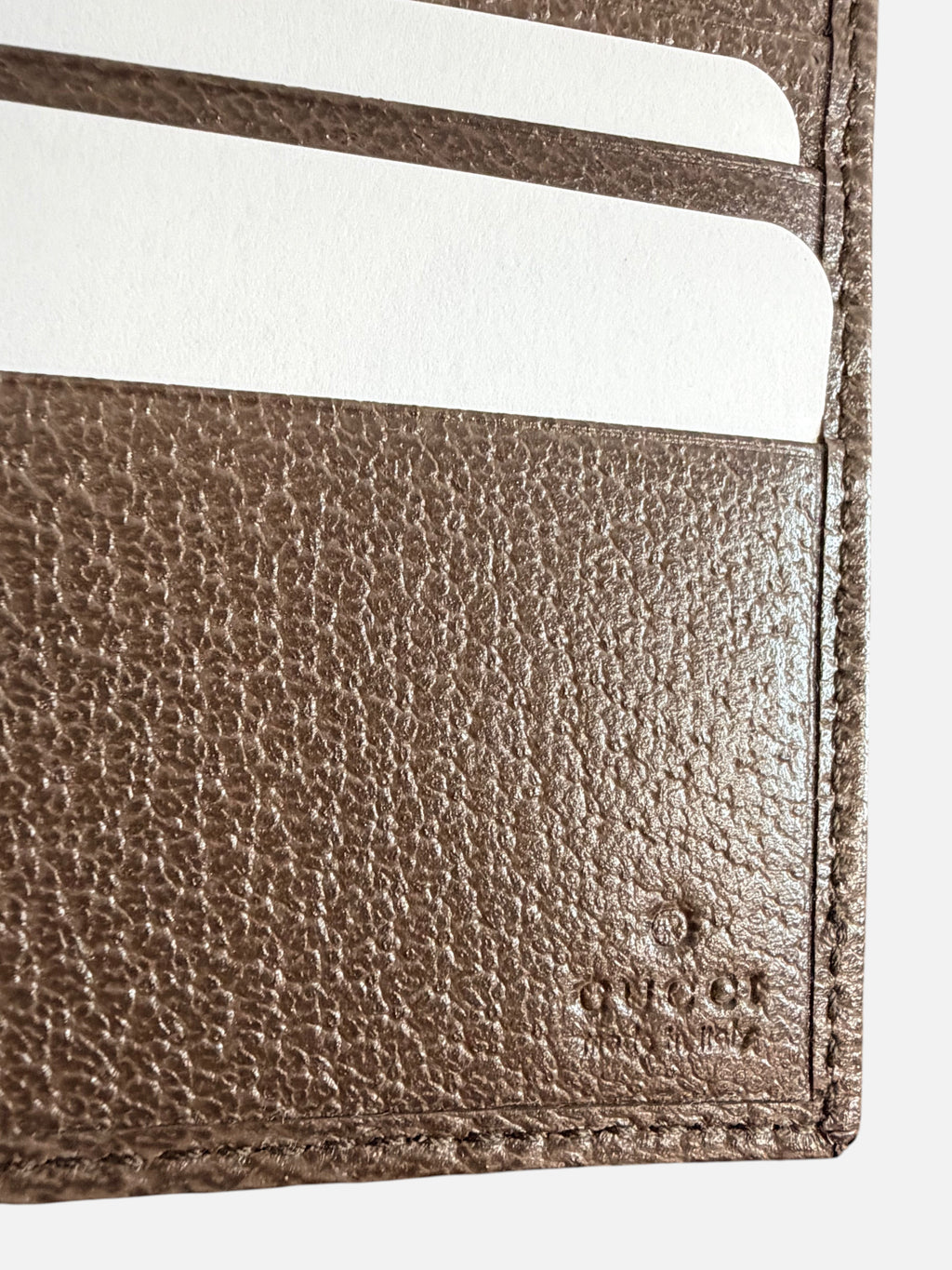 CURATED by Kira Gucci bifold wallet interior featuring brown leather texture and embossed logo detail