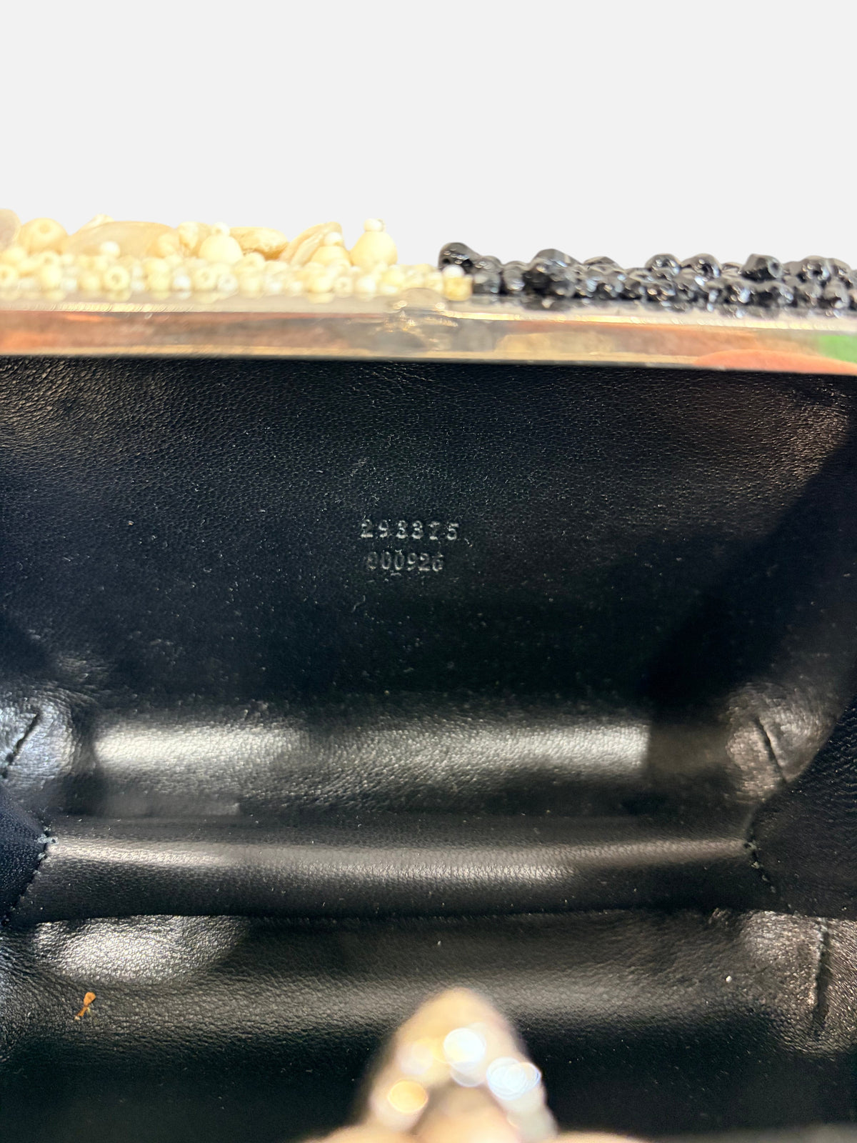 CURATED by Kira Alexander McQueen shell and bead clutch interior showing serial number stamped on black leather lining