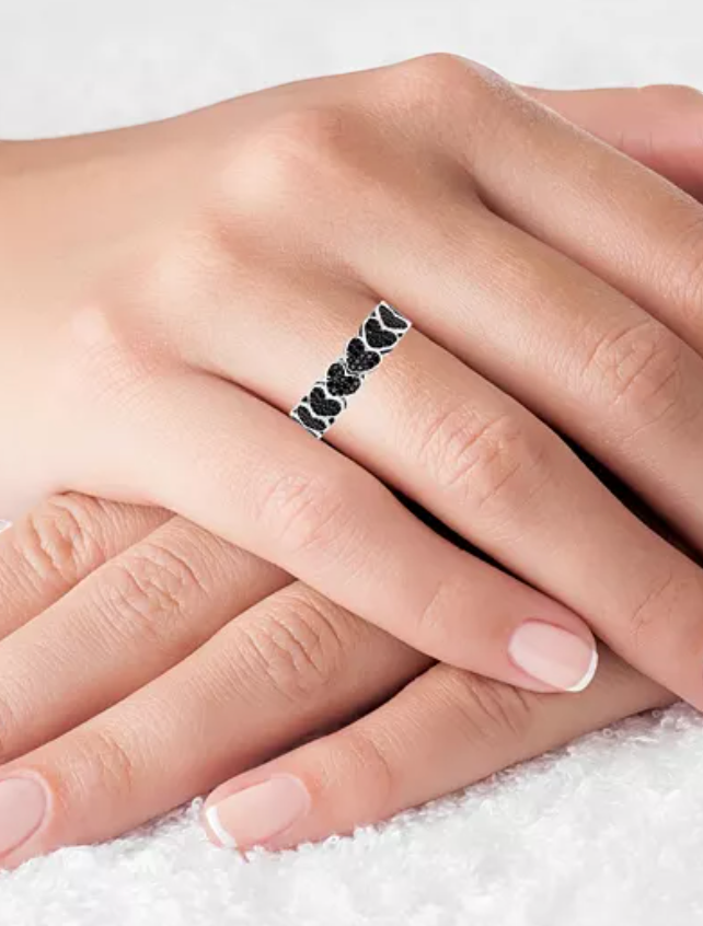 CURATED by Kira eternity ring featuring pave set black spinel stones in heart shapes on rhodium plated silver