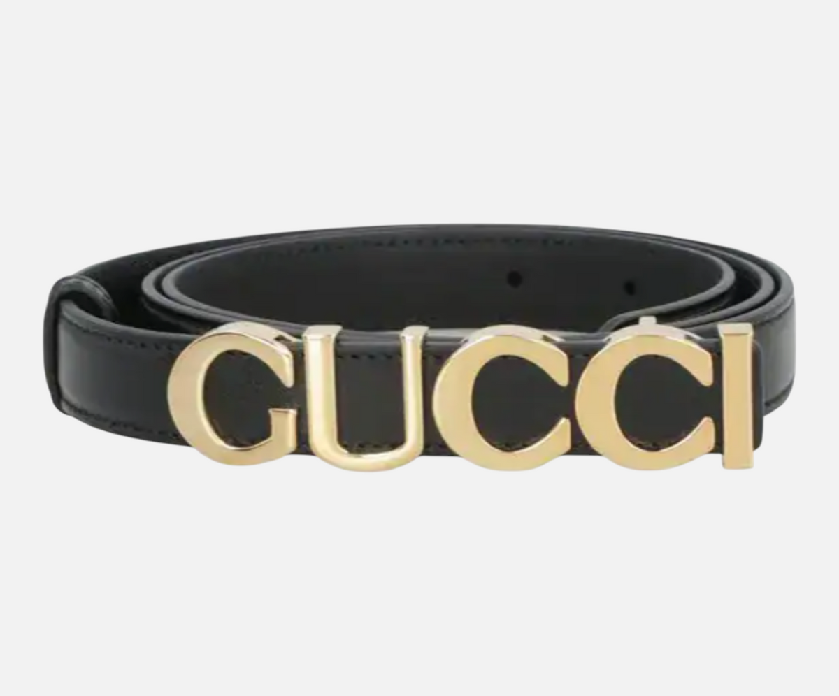 CURATED by Kira Gucci black cowhide leather belt featuring a prominent gold-tone logo buckle for a luxury aesthetic.