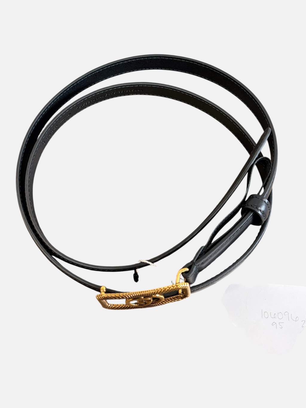CURATED by Kira black leather Gucci belt with gold-tone GG buckle, size 95, displayed on a rustic wooden surface.