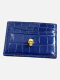 CURATED by Kira Alexander McQueen navy patent crocodile embossed leather card holder with gold skull detail.