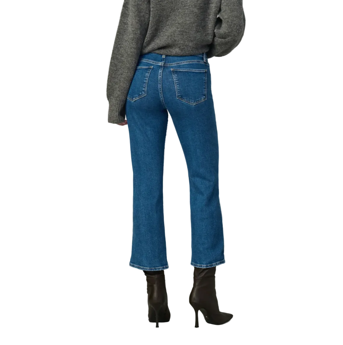 Person wearing blue jeans and a gray sweater on a plain background