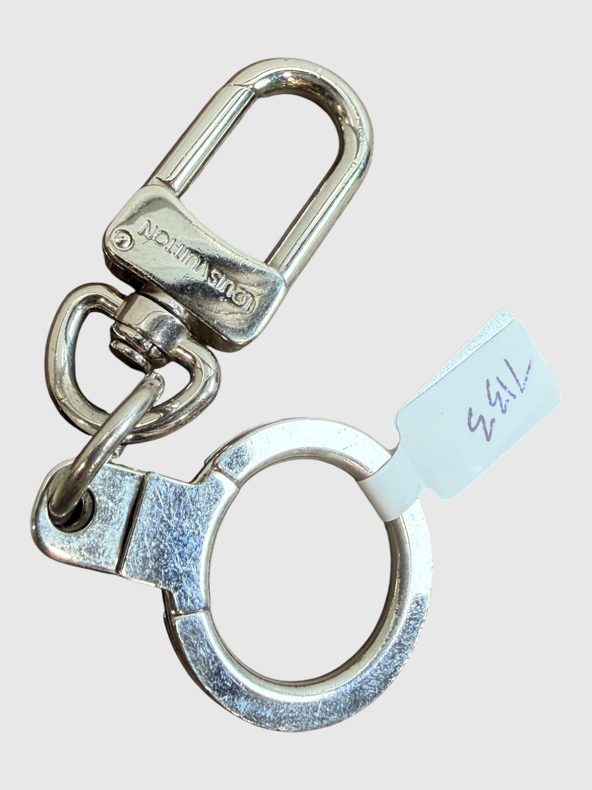 CURATED by Kira Louis Vuitton Traveling Requisites silver metal keychain bag charm with engraved logo clasp