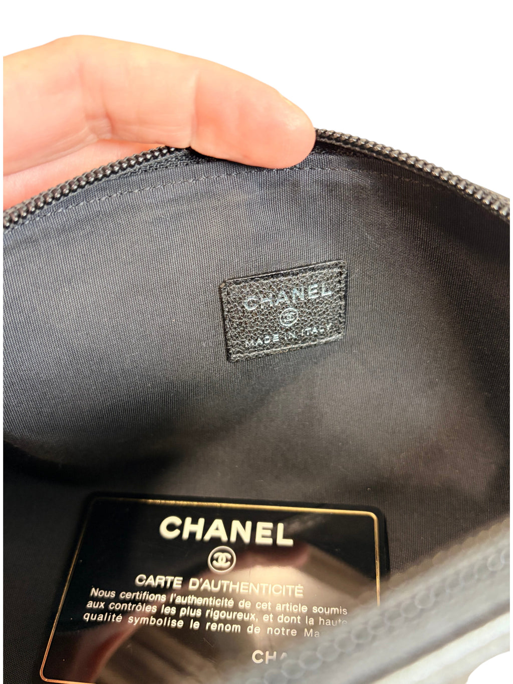 CURATED by Kira Chanel cosmetic pouch interior featuring black fabric lining, leather logo patch, and authenticity card