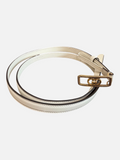 CURATED by Kira Gucci GG buckle leather belt in mystic white with gold-tone hardware on a rustic wooden surface