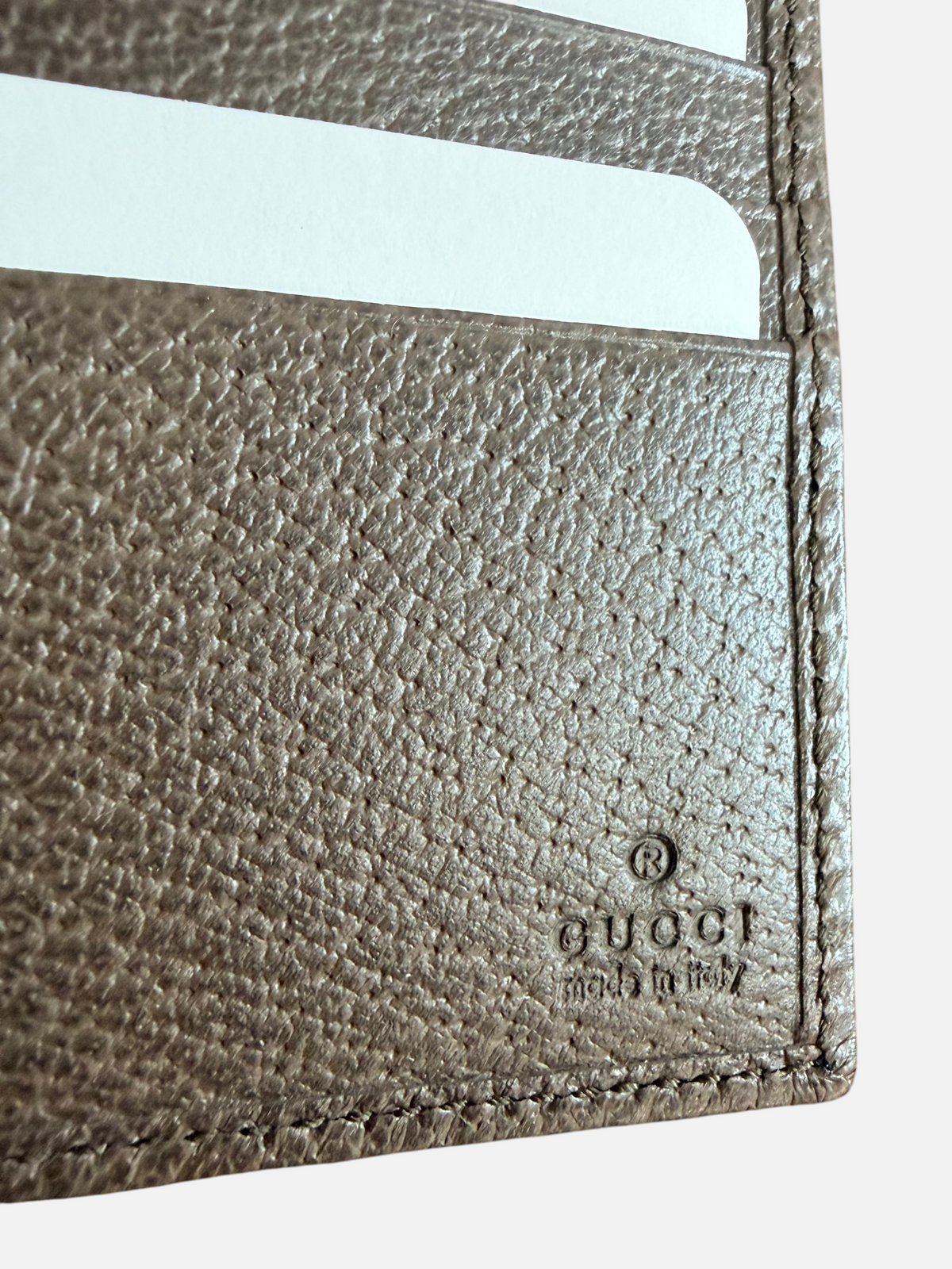 CURATED by Kira Gucci bifold wallet interior featuring brown leather texture and embossed logo detail