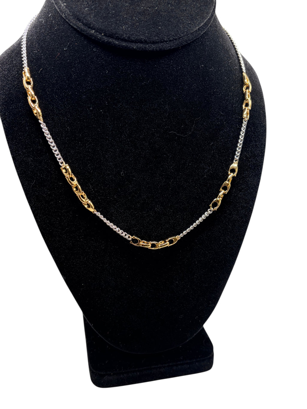 CURATED by Kira COACH two-tone brass mixed chain necklace with signature sculpted C links on a black display bust.