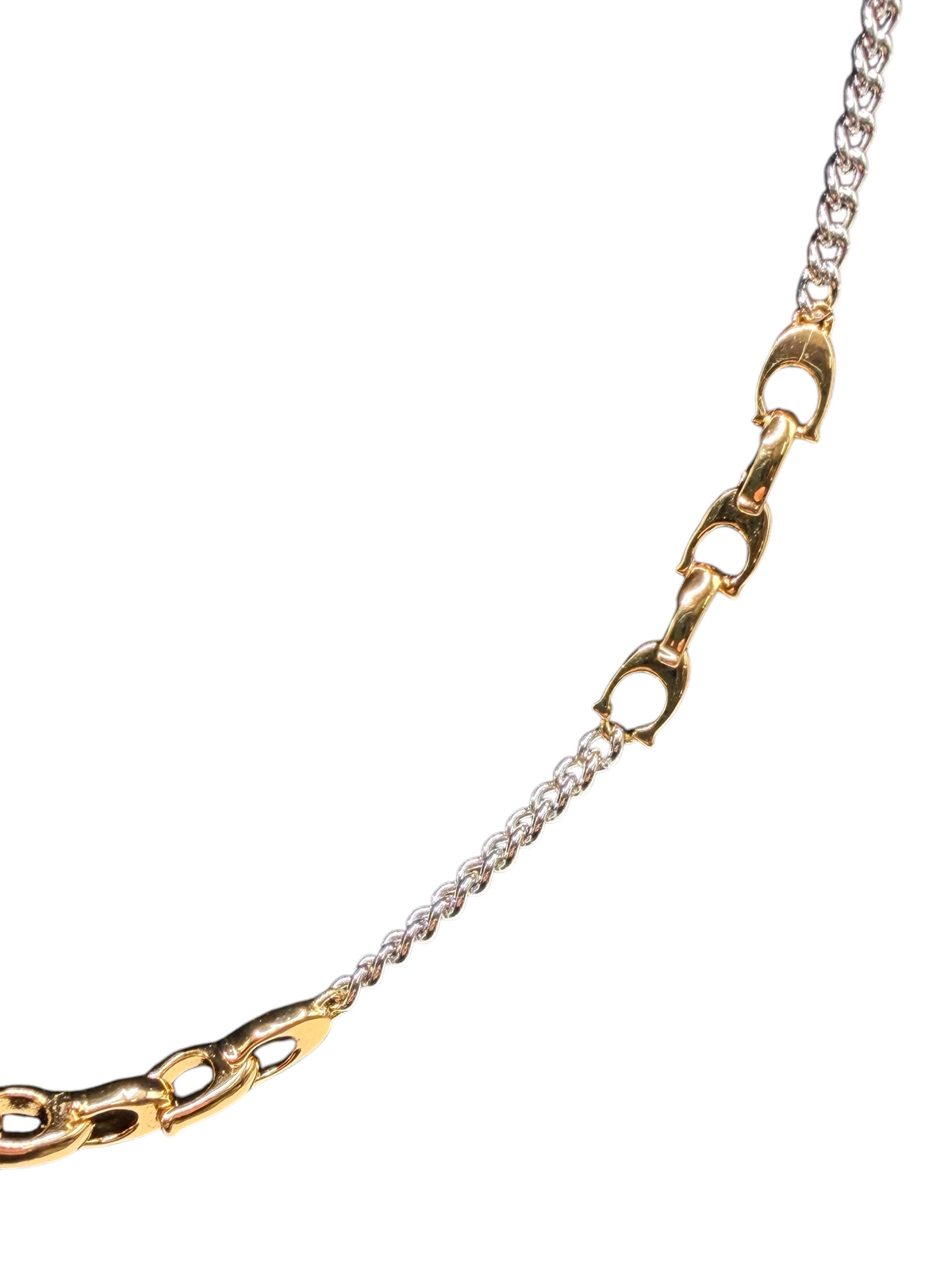 CURATED by Kira Coach two-tone brass mixed chain necklace with signature sculpted C links on a black display bust