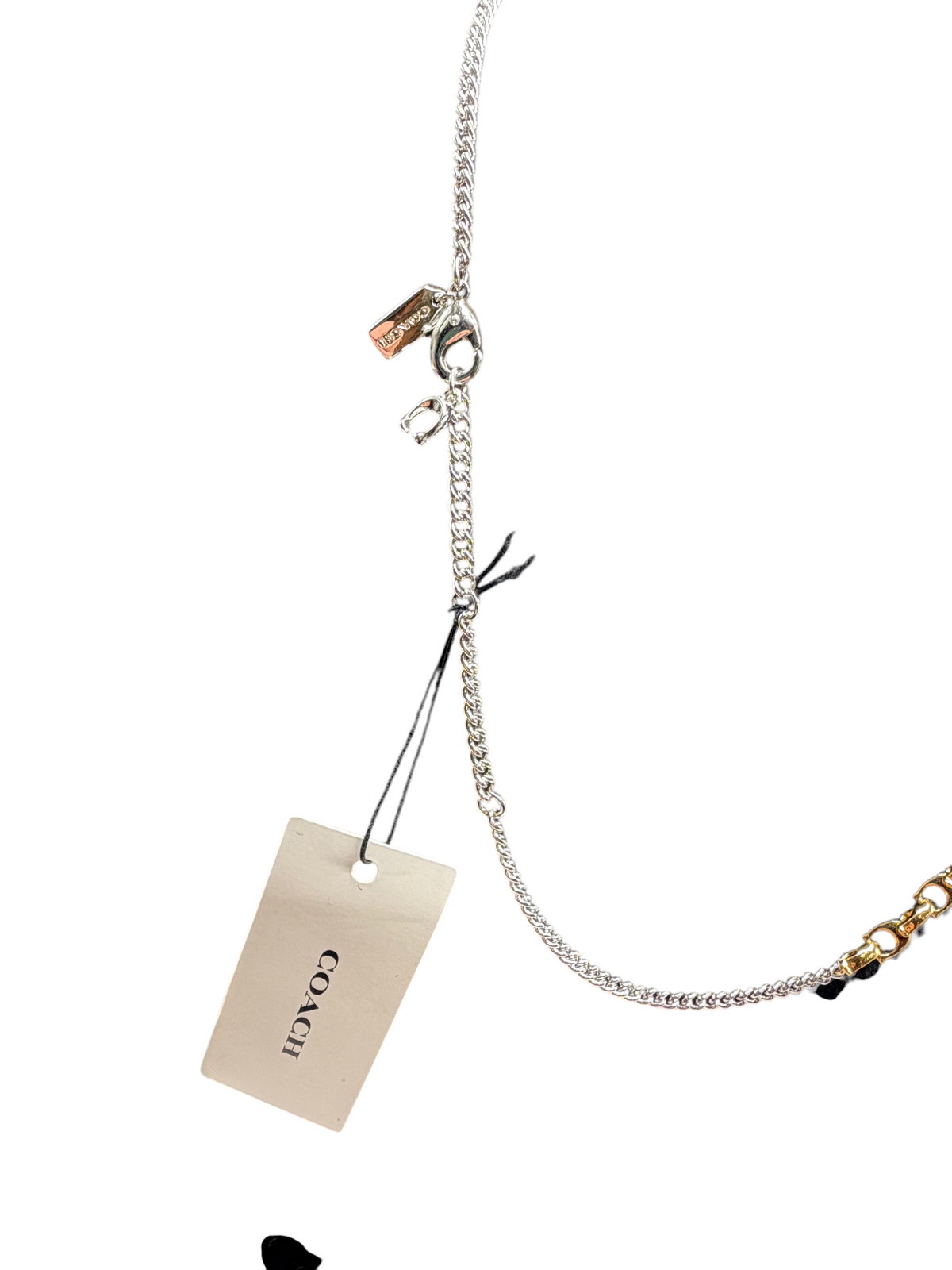 CURATED by Kira Coach two-tone brass mixed chain necklace with signature C links and logo tag on black display bust