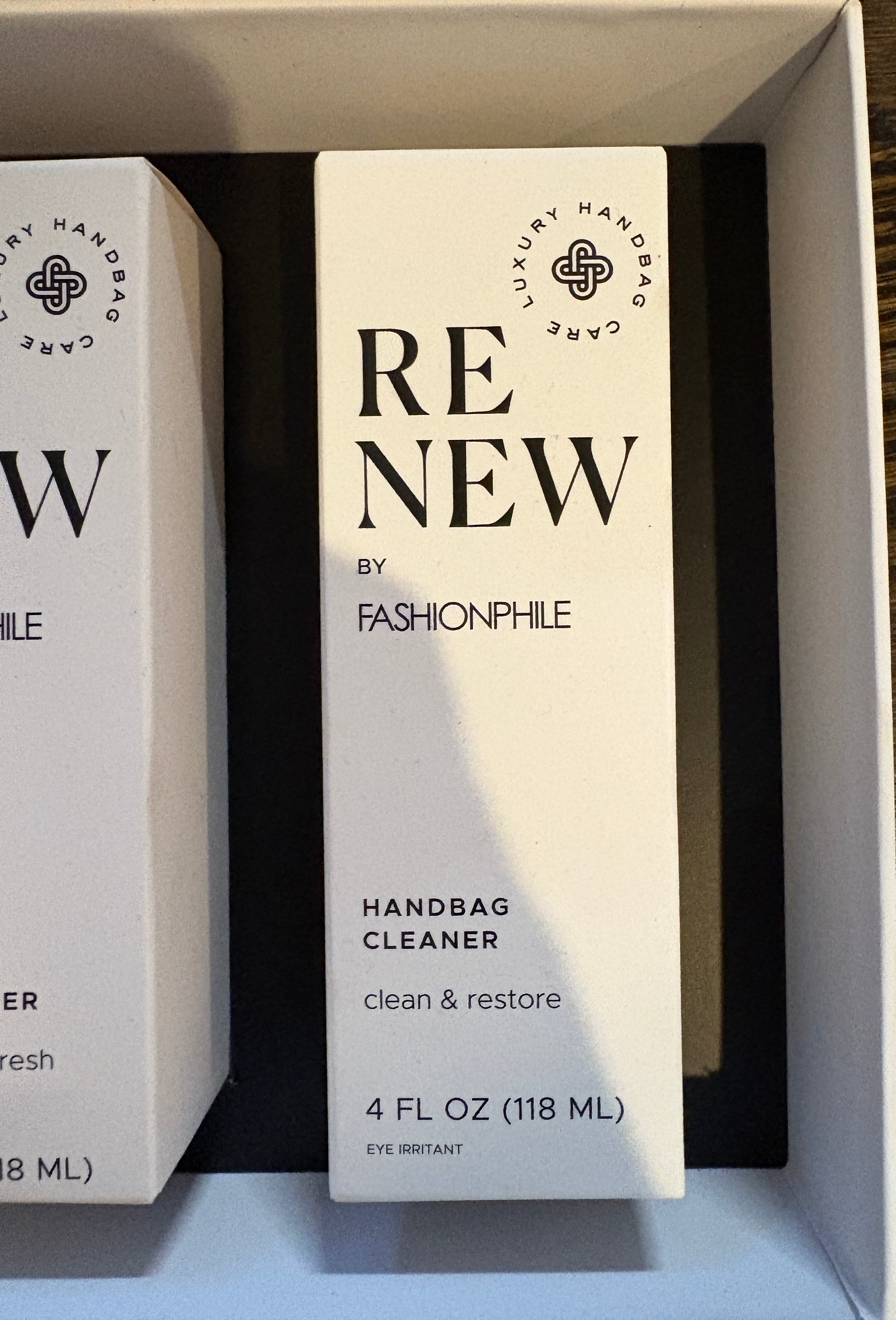 Two bottles of 'RENEW' handbag cleaner by Fashionphile in a box.