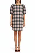 Plaid dress on a hanger against a white background