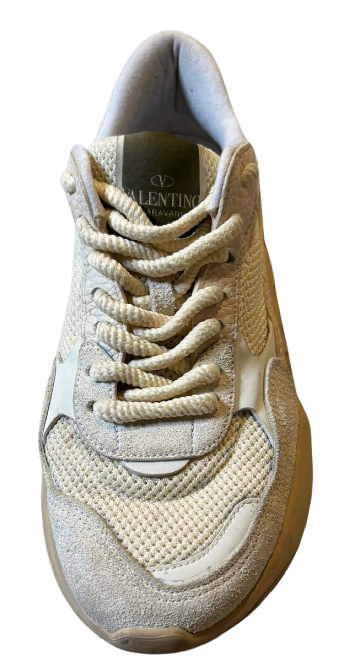 Beige sneaker with lace-up design on a white background
