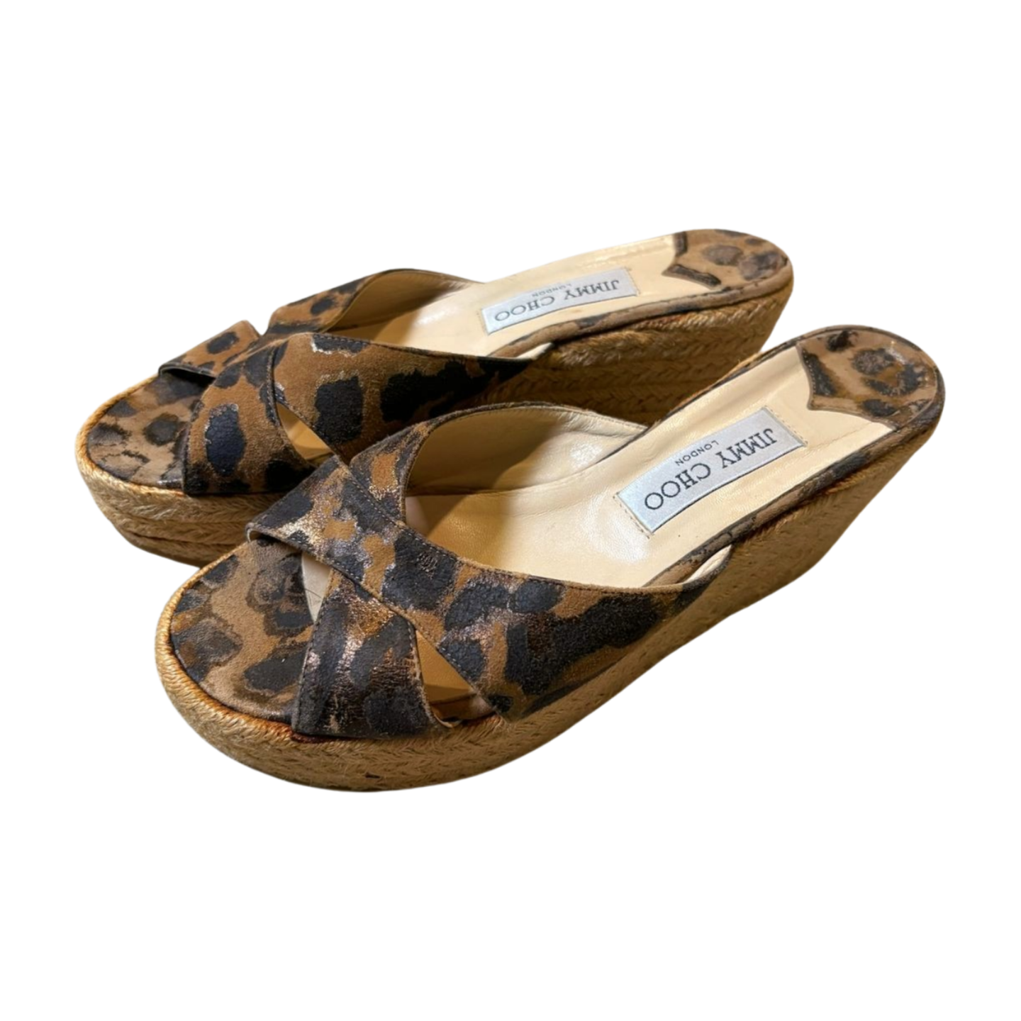Pair of leopard print sandals with wooden soles on a white background