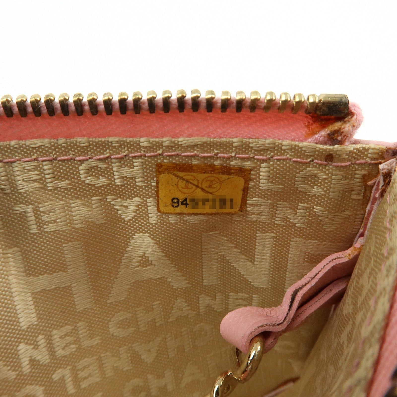 CURATED by Chanel pink quilted leather zip-around card holder with gold hardware and floral charm.