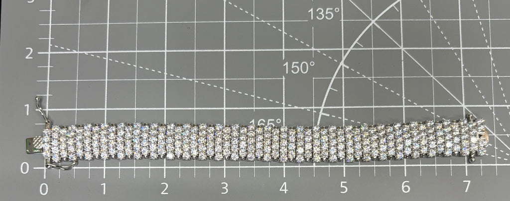CURATED by Kira wide 5-row sterling silver tennis bracelet featuring sparkling round-cut cubic zirconia stones.