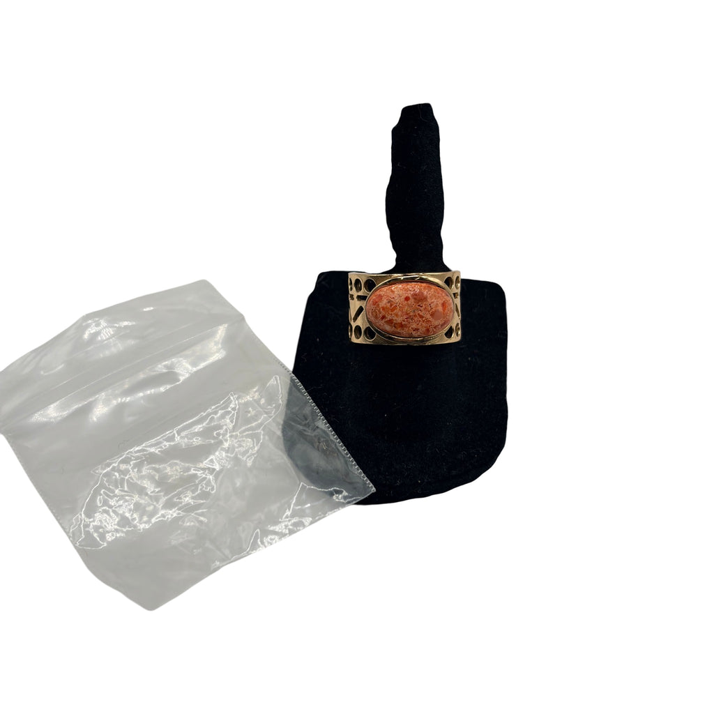 CURATED by Kira Barse Pharaoh ring featuring an oval orange sponge coral stone set in a gold Egyptian style band
