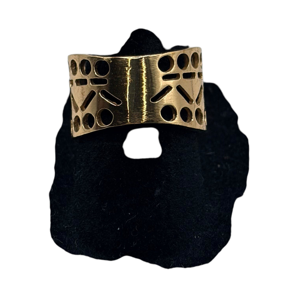 CURATED by Kira Barse Pharaoh gold-tone band ring with Egyptian-inspired geometric cutouts on a black display stand.