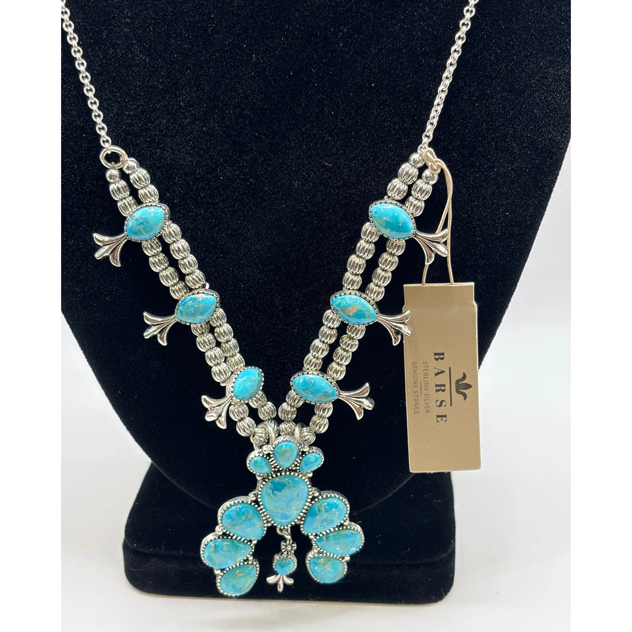 CURATED by Kira Barse sterling silver squash blossom necklace featuring teal turquoise stones on a silver chain