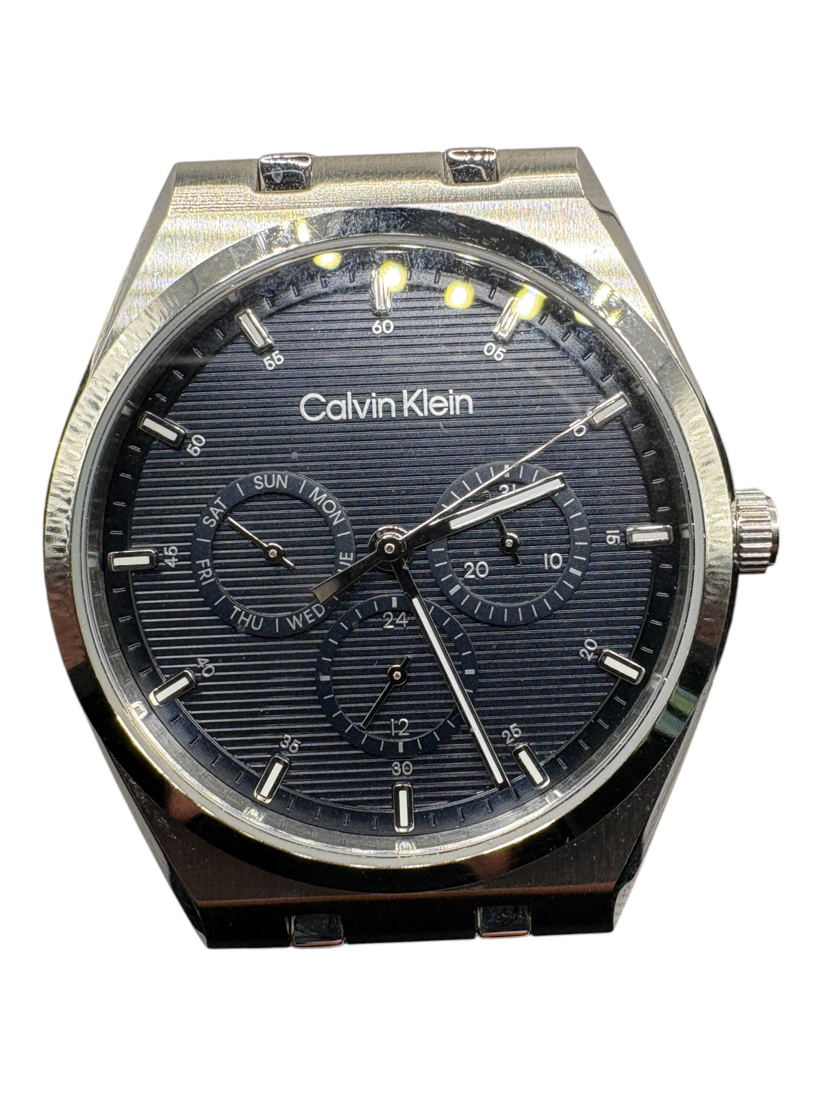 CURATED by Kira Calvin Klein Motion men's watch with a textured navy blue dial and silver stainless steel case.