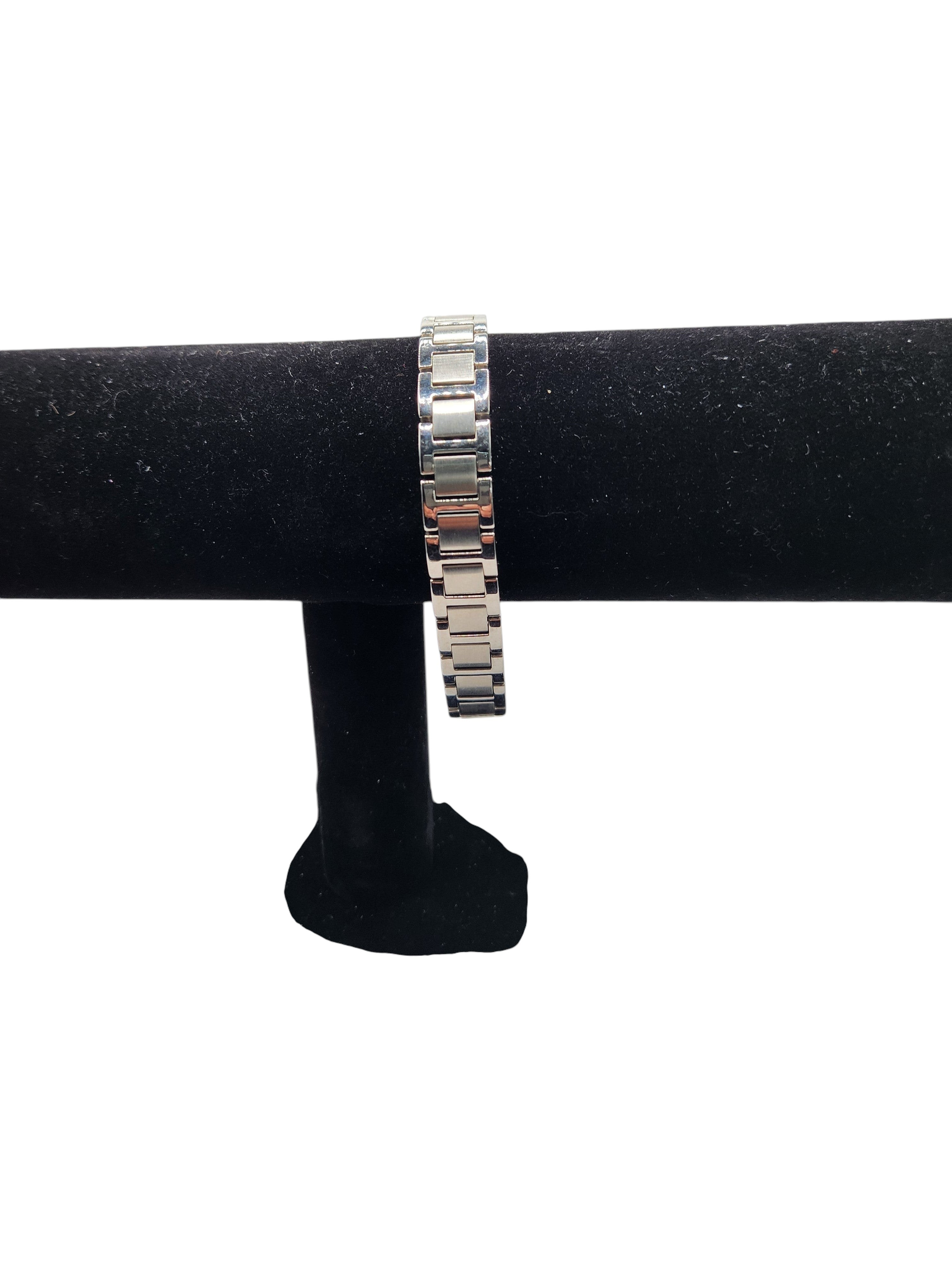 CURATED by Kira Caravelle silver-tone stainless steel link bracelet with brushed and polished finish on display stand