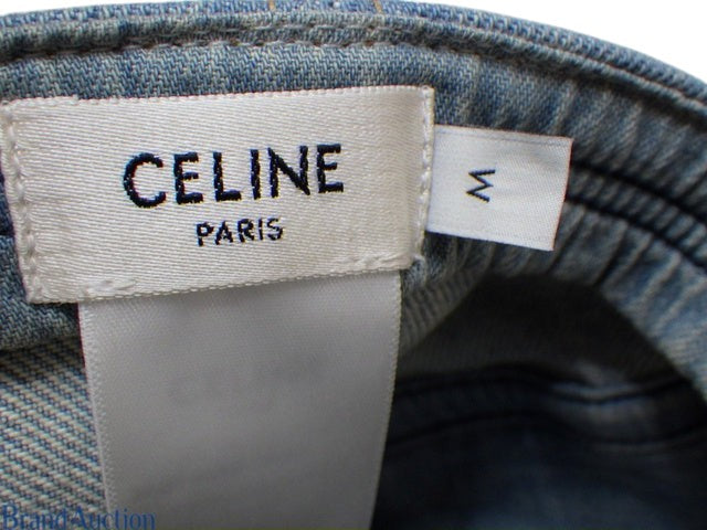 CURATED by Kira Celine denim cap interior label showing size M and Paris branding on blue fabric