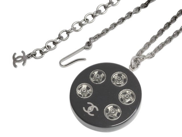 CURATED by Kira Chanel Coco Tire necklace with silver chain and black pendant featuring interlocking CC logo and five decorative elements.