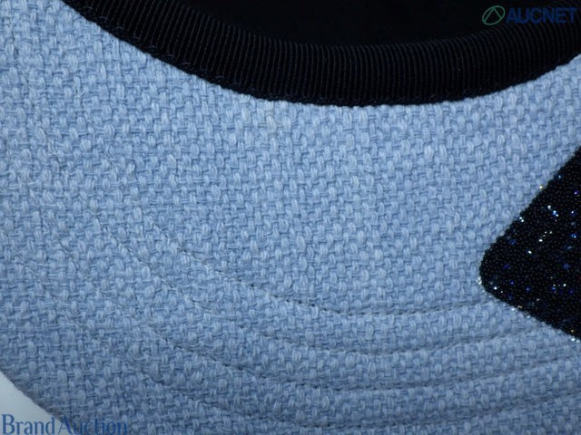 CURATED by Kira Chanel denim hat featuring light blue textured fabric and a dark blue brim detail