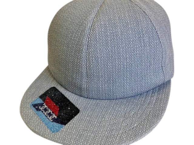 CURATED by Kira Chanel denim baseball hat in light blue with a decorative embroidered patch on the brim