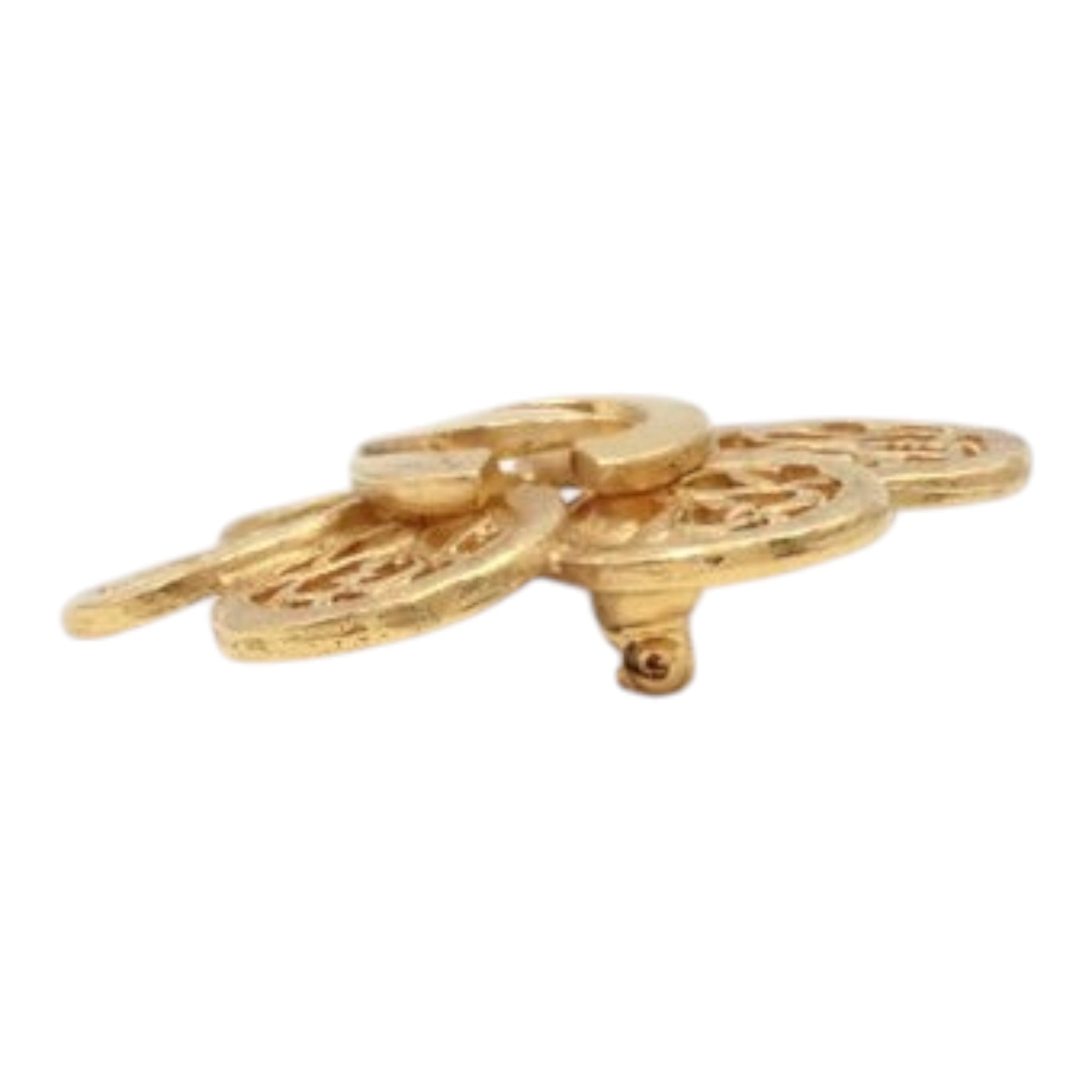 CURATED by Kira gold Chanel Coco Mark brooch featuring intricate cutout floral details in a side profile view