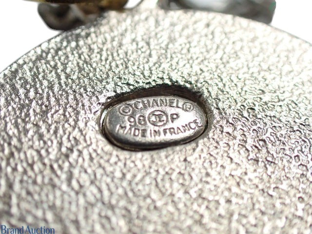 CURATED by Kira Chanel 98P round necklace featuring a textured silver and gold metal hallmark plate