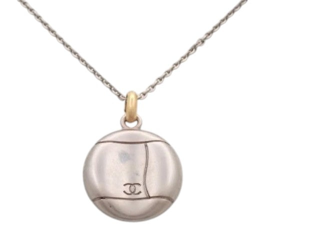 CURATED by Kira vintage Chanel round Coco pendant necklace featuring a two-tone silver and gold design on a chain.