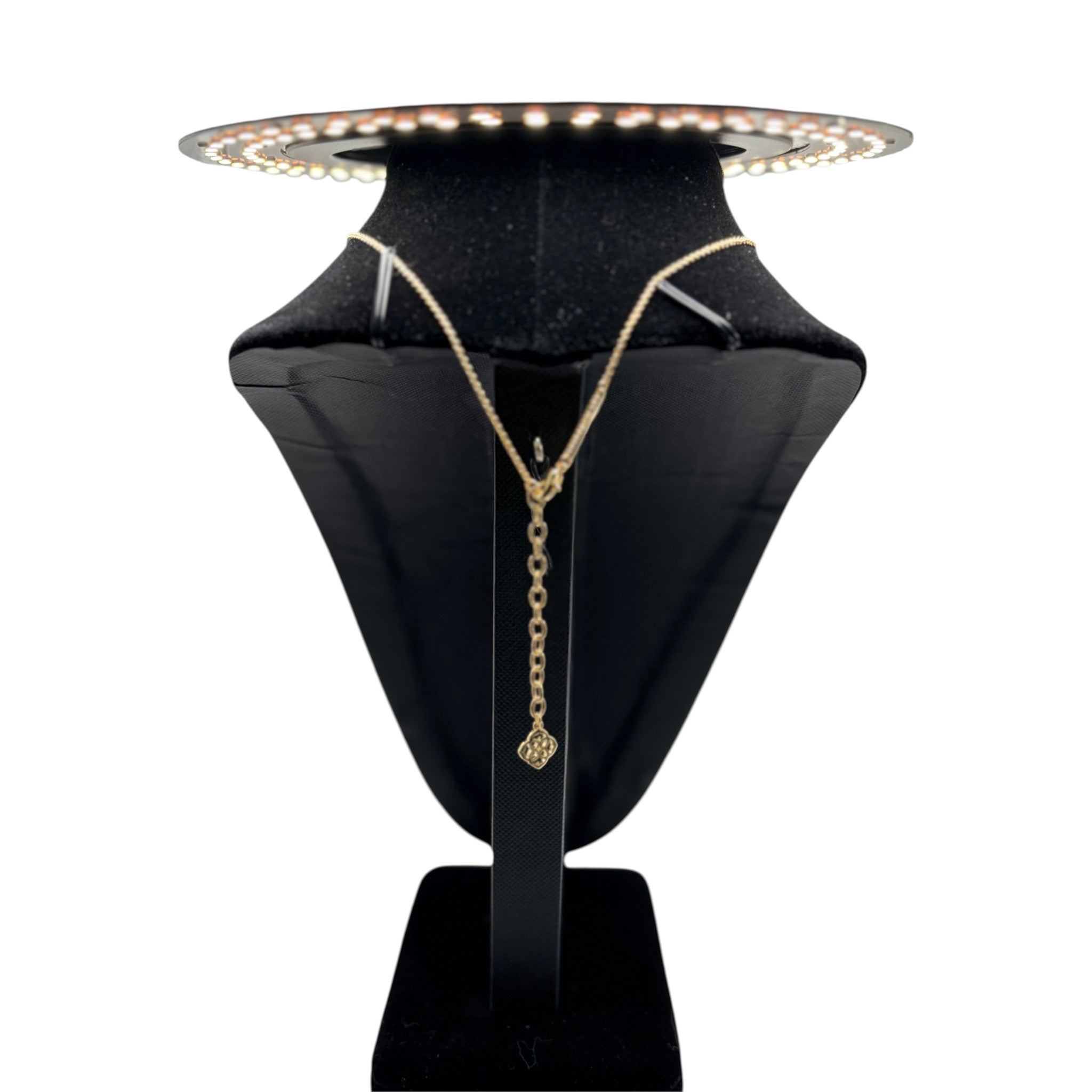 CURATED by Kira Kendra Scott style Elisa pendant necklace featuring a gold chain and red orange stone on a display
