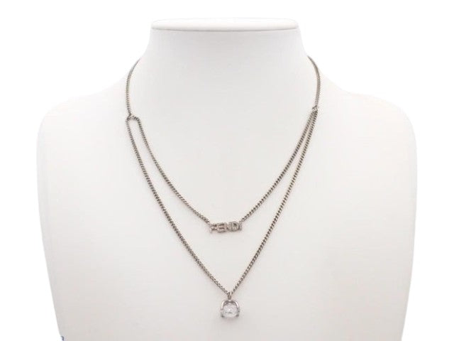 CURATED by Kira Fendi silver double chain necklace with Fendi logo charm and crystal pendant on a display bust