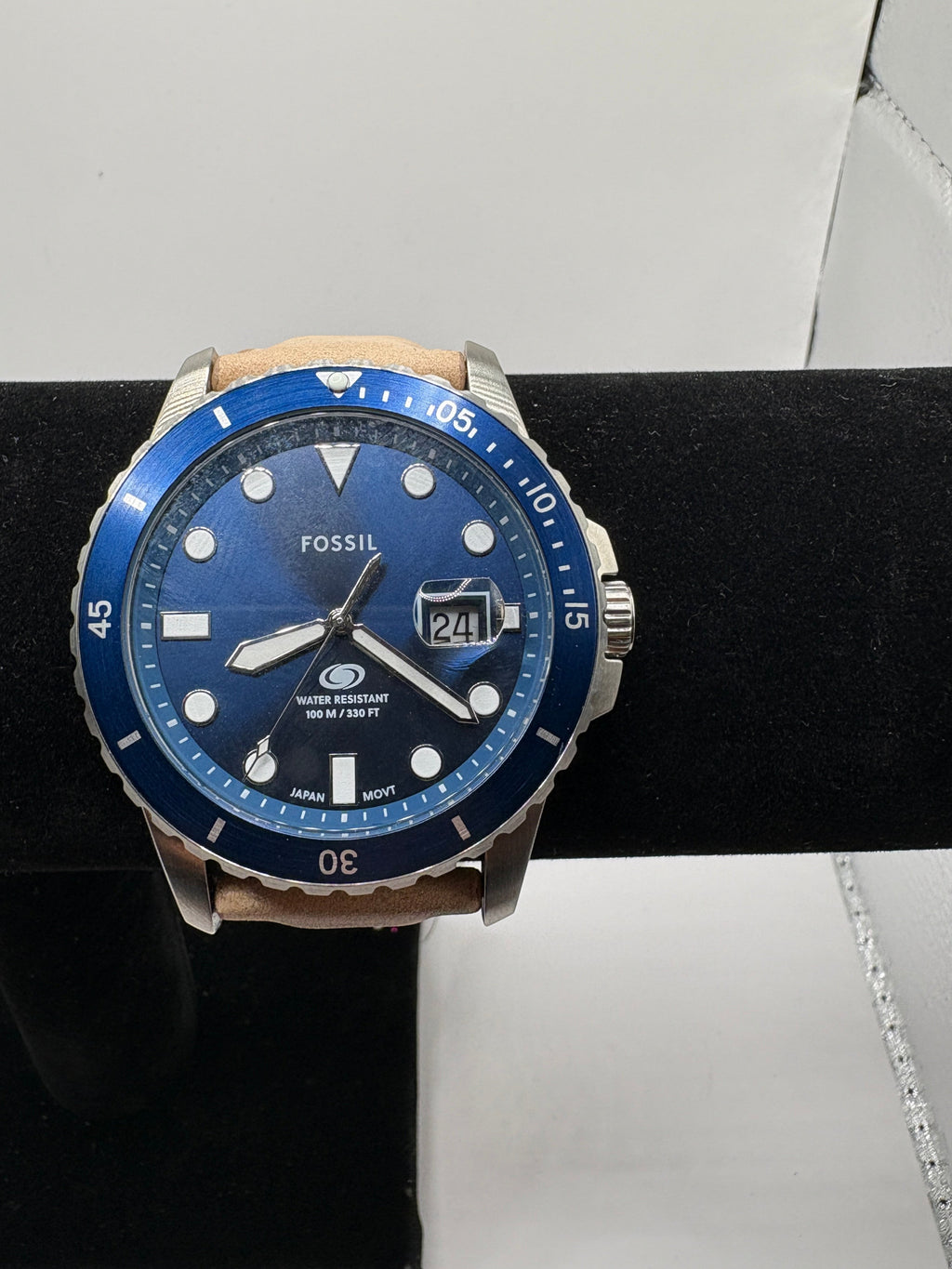 CURATED by Kira Fossil Blue dive watch with a blue dial, stainless steel case, and a tan leather strap.