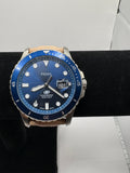 CURATED by Kira Fossil Blue dive watch with a blue dial, stainless steel case, and a tan leather strap.