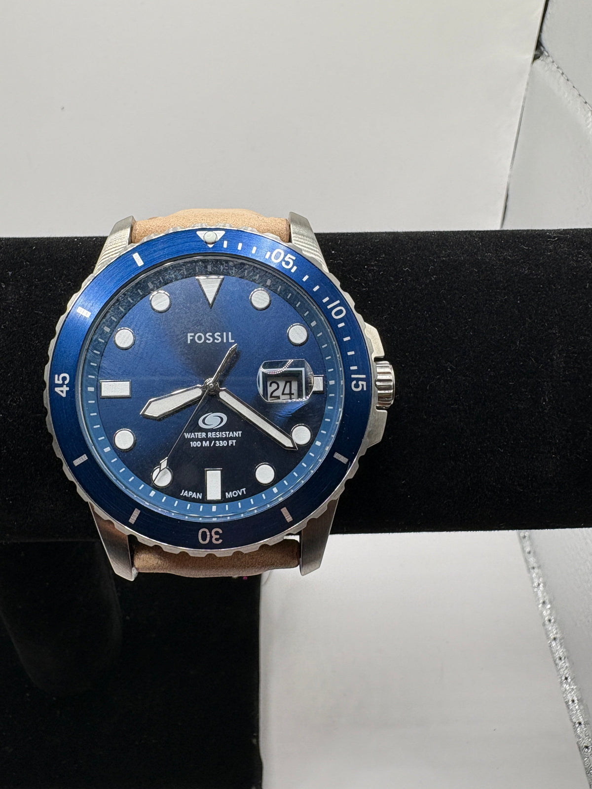 CURATED by Kira Fossil Blue dive watch with a blue dial, stainless steel case, and a tan leather strap.