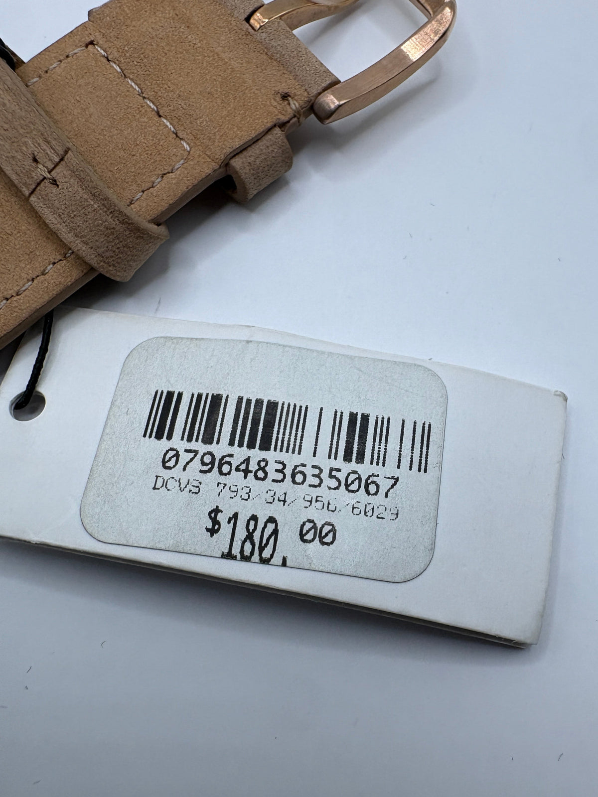 CURATED by Kira tag showing barcode and price for Fossil watch with beige leather strap and rose gold buckle