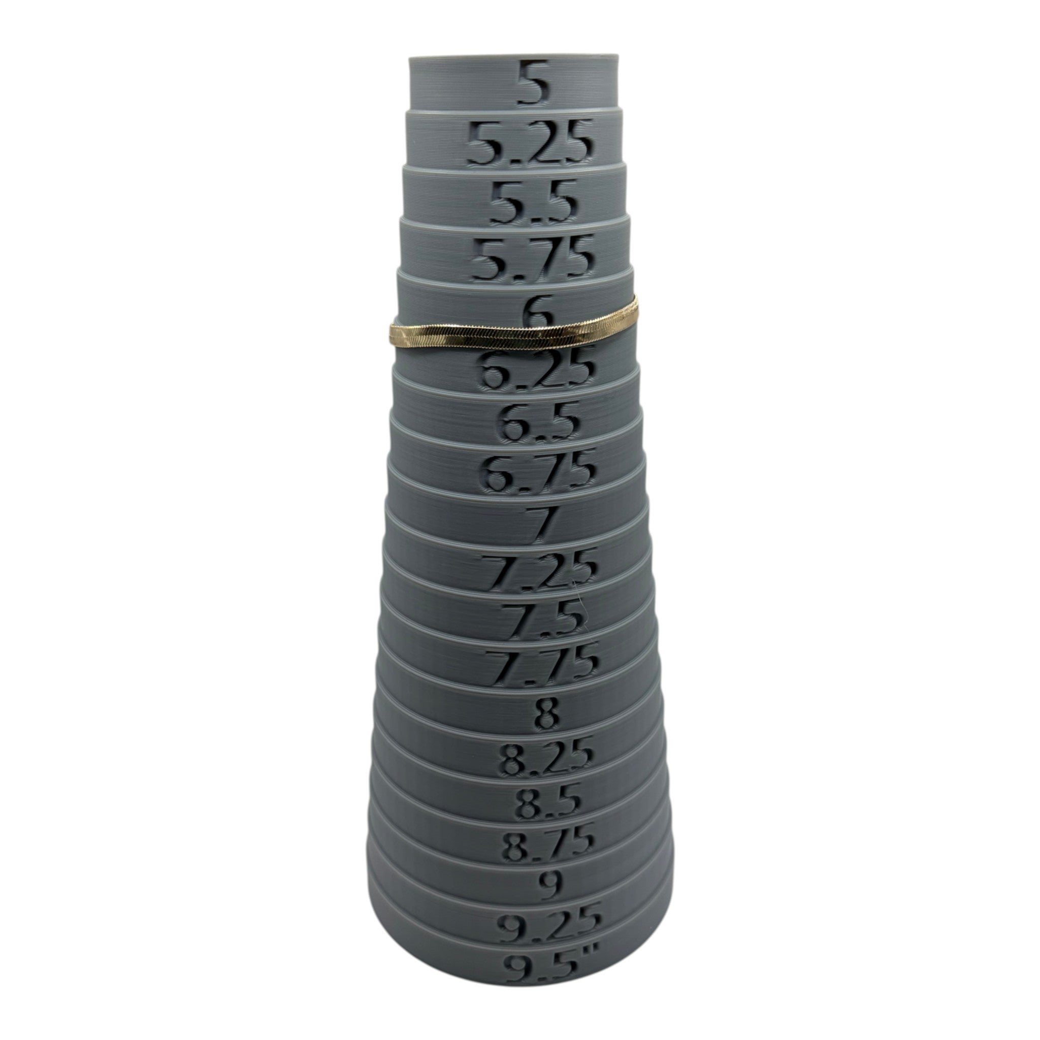 CURATED by Kira gold tone Kate Spade herringbone chain bracelet resting on a grey plastic ring sizer at size 6