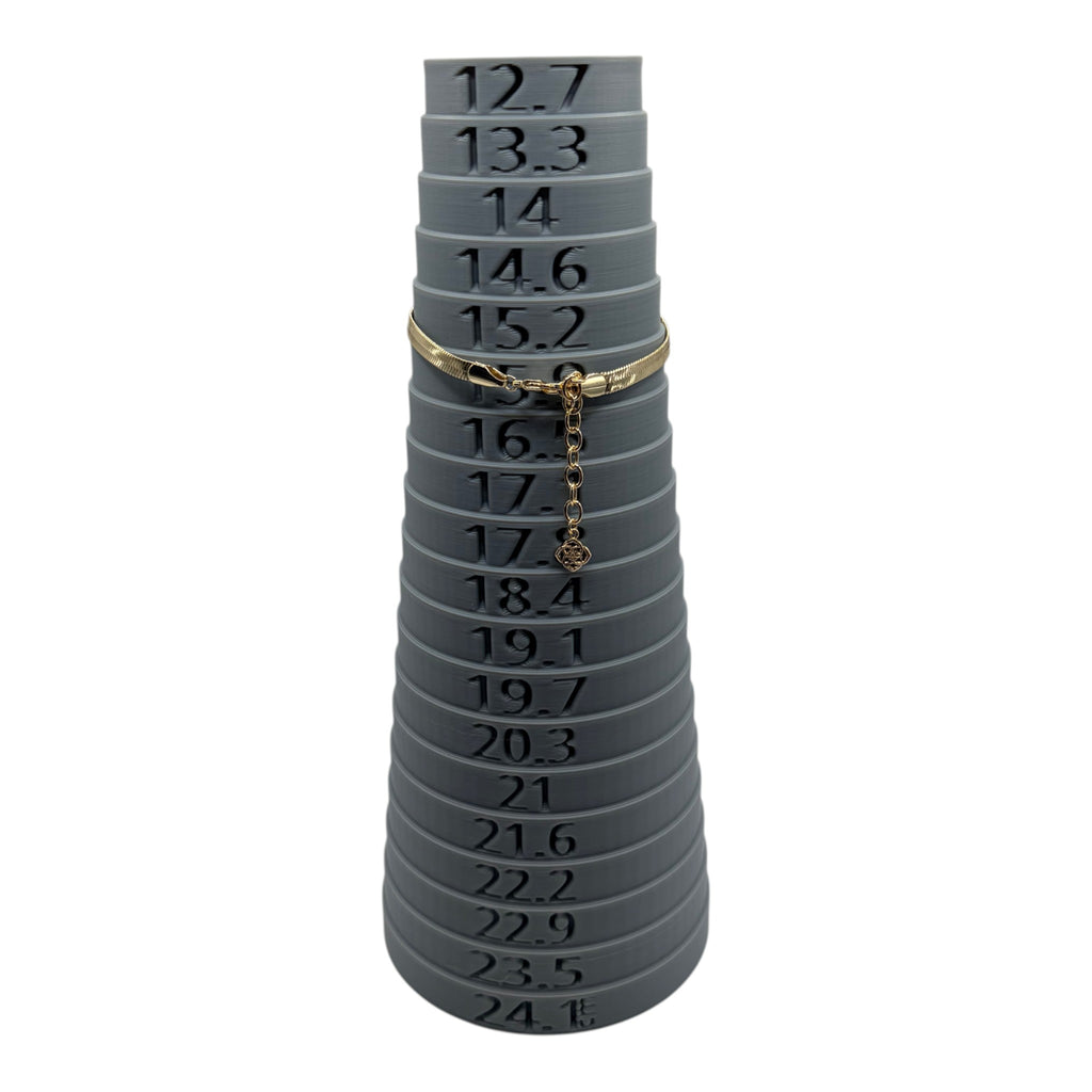CURATED by Kira gold tone Kate Spade herringbone chain bracelet on a grey ring sizer display