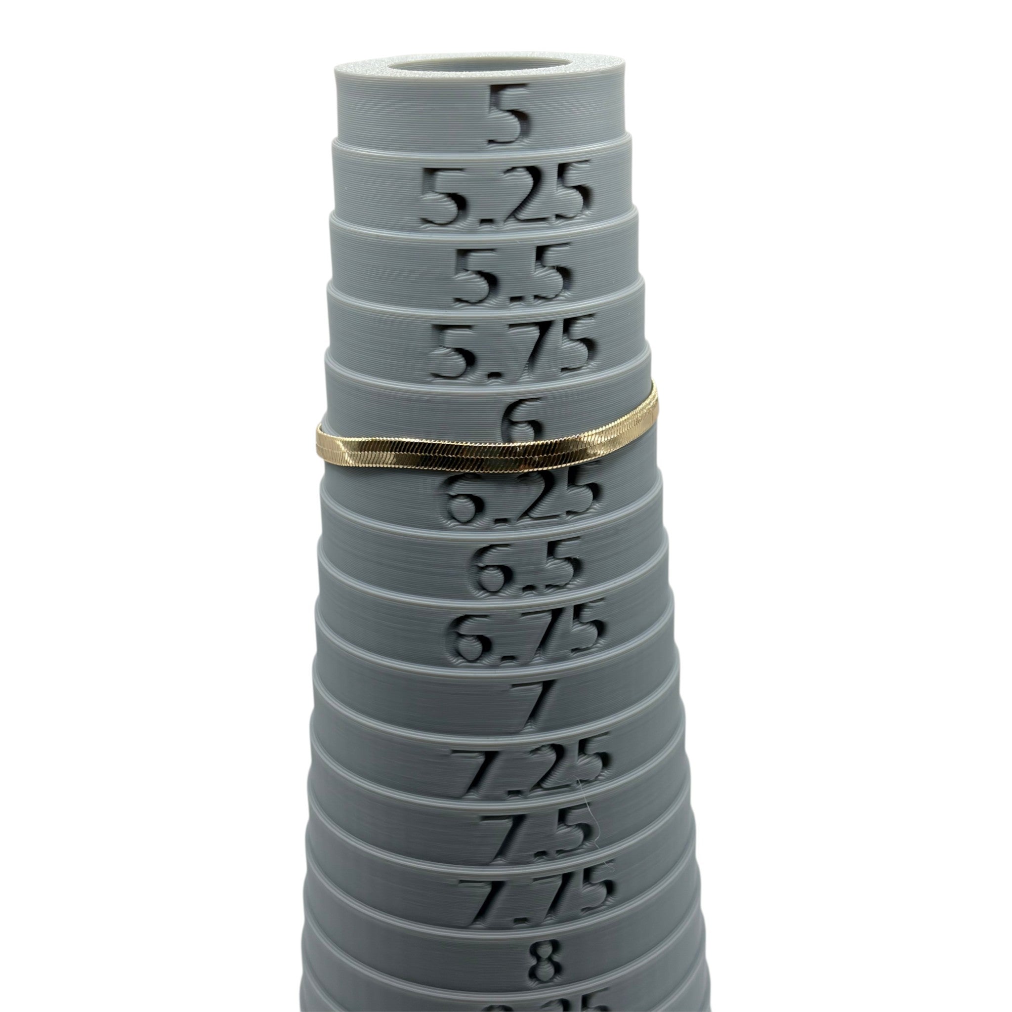 CURATED by Kira gold tone Kate Spade herringbone chain bracelet shown on a grey ring sizer at size 6