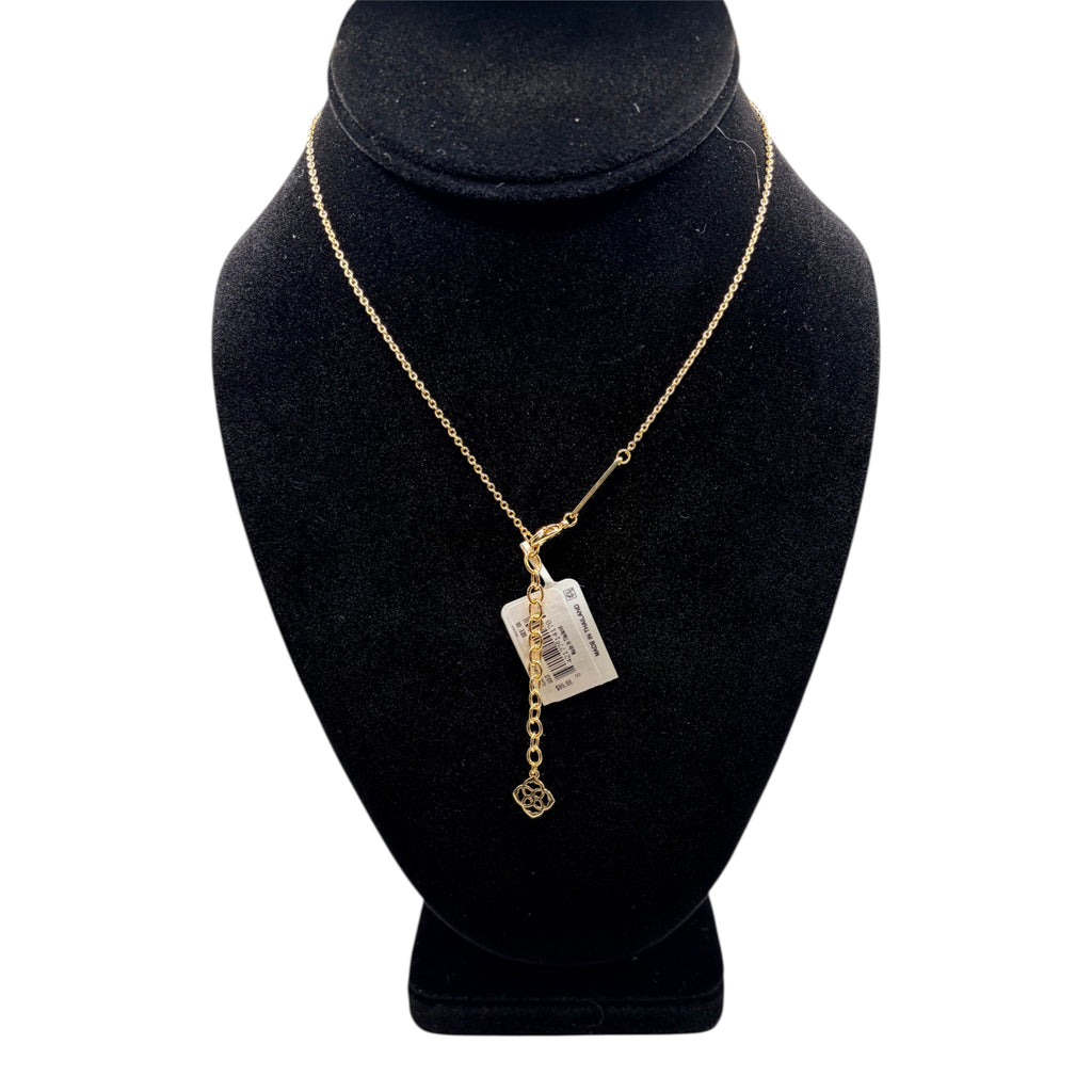 CURATED by Kira gold pendant necklace with delicate chain and floral charm on a black display bust