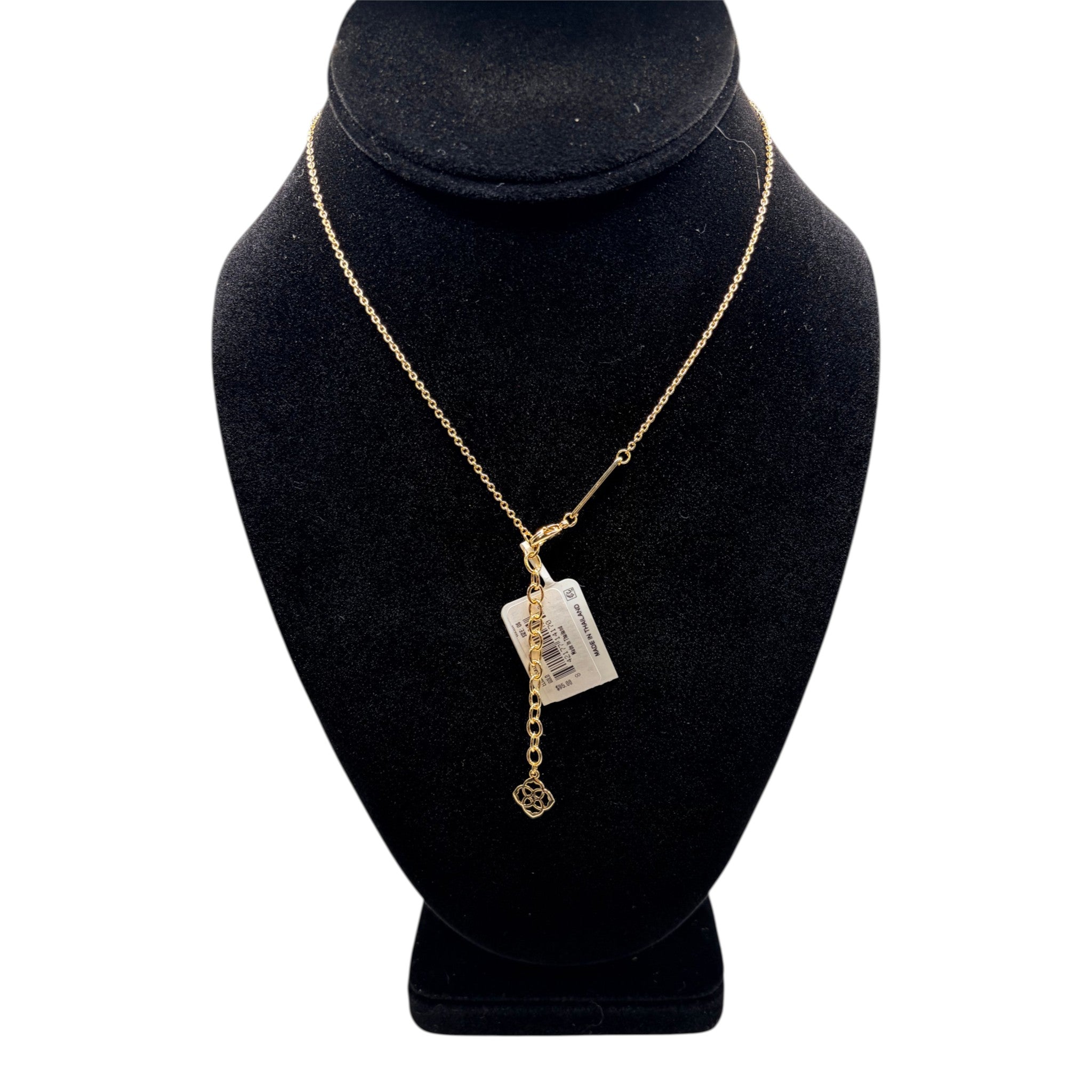 CURATED by Kira gold pendant necklace with delicate chain and floral charm on a black display bust