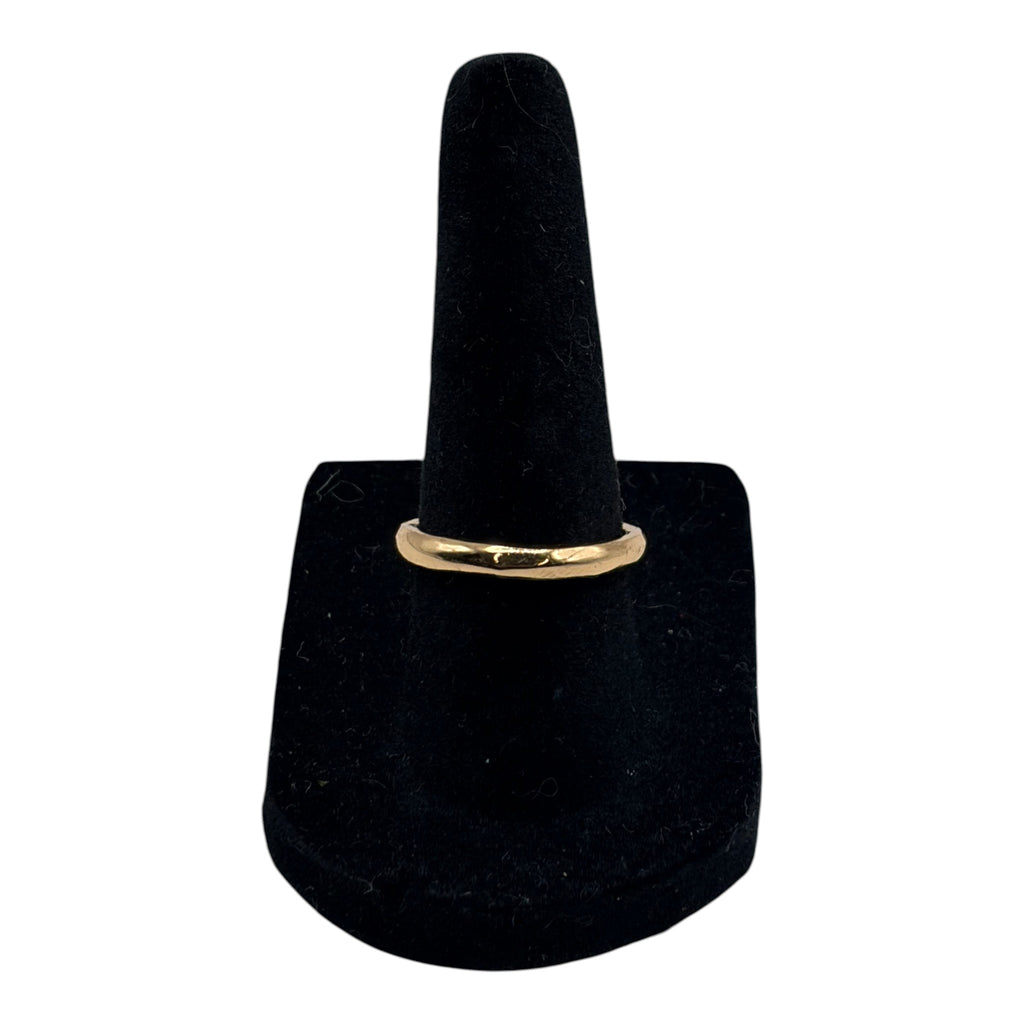 CURATED by Kira gold tone simple band ring displayed on a black velvet ring stand