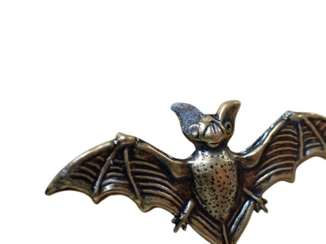 CURATED by Kira Gucci Garden bat brooch in a metallic yellow gold finish with detailed wing textures