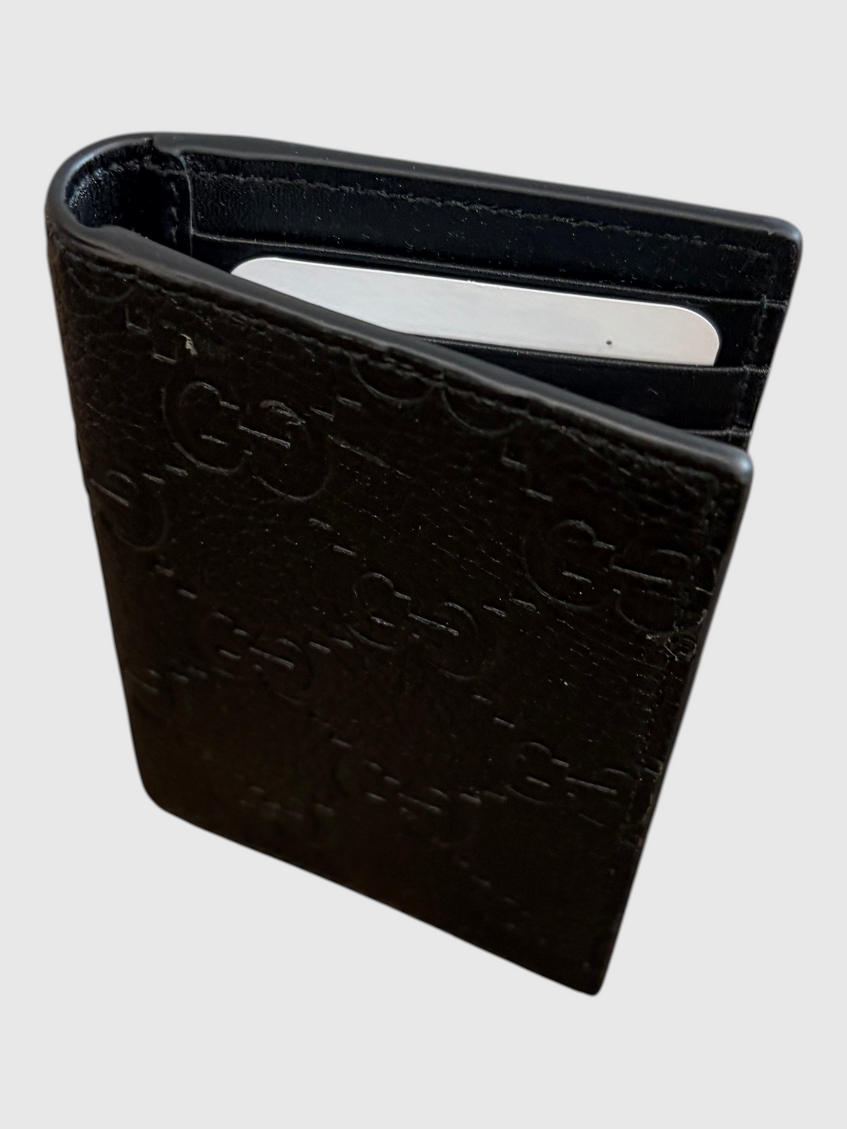 CURATED by Kira black grainy calfskin Gucci bifold card case with embossed GG logo pattern