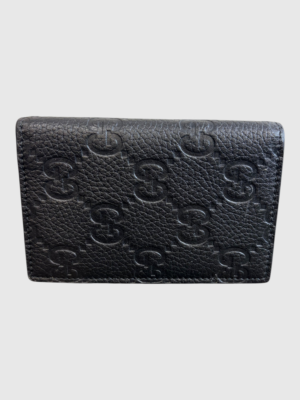 CURATED by Kira black grainy calfskin Gucci card case with embossed GG logo pattern