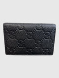 CURATED by Kira black grainy calfskin Gucci card case with embossed GG logo pattern